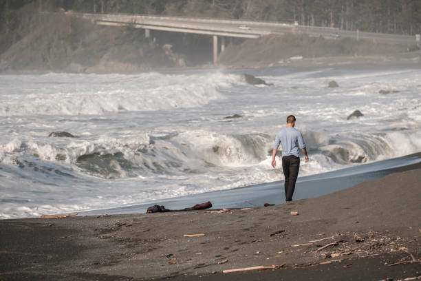 istock Lone man at USA Pacific coast beach 675272208