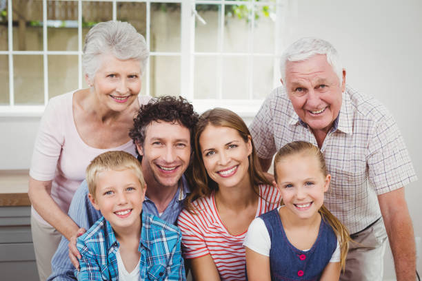 istock Happy multi-generation family against window at home 675272634