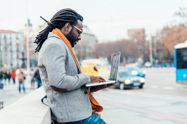 istock Businessman using his laptop in the Street. 675272836