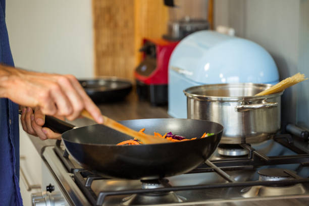 istock Man preparing food in kitchen 675275968