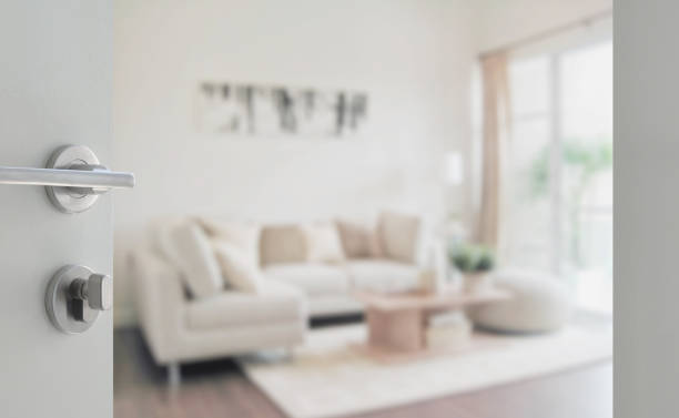 opened white door to modern living room interior stock photo
