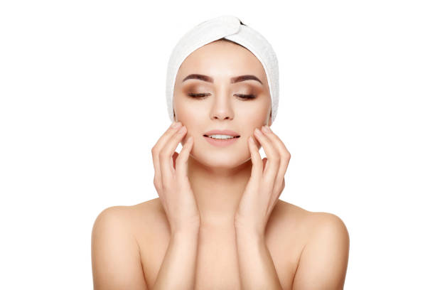 istock Beautiful young woman touching her face on a white background 675285856