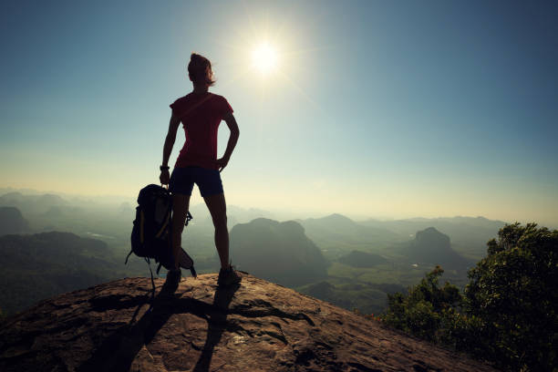 istock successful woman backpacker hiking on sunrise mountain top 675291824