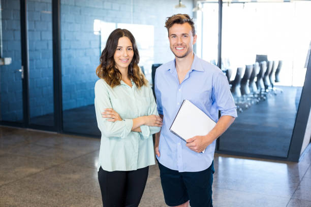 istock Portrait of colleagues standing in office 675292464