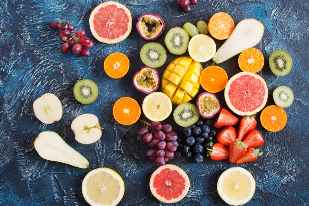 istock Raw fruits platter on the dark blue table 675292484