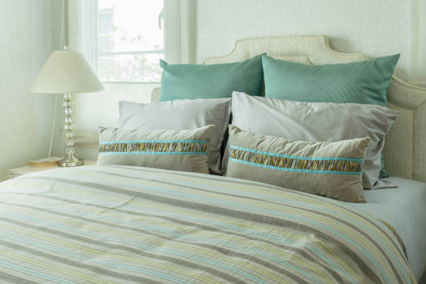 istock cozy bedroom interior with pillows and reading lamp on bedside table 675292520