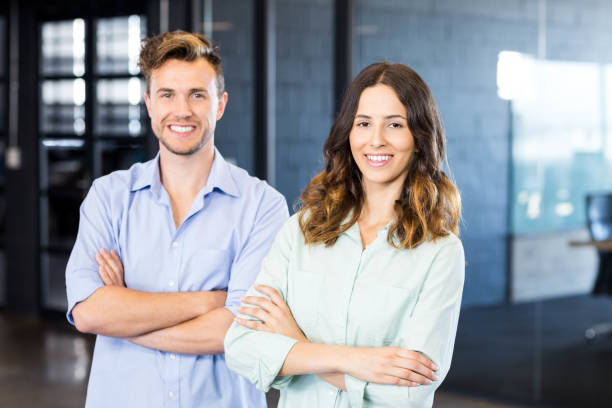 istock Portrait of colleagues standing in office 675292596