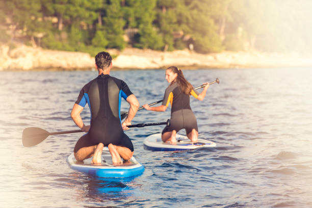 istock Paddle boarder couple talking at sea 675298450