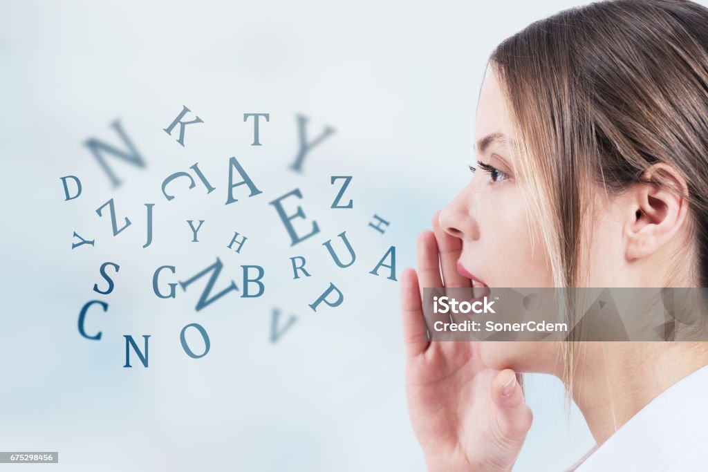 Woman talking with alphabet letters coming out of her mouth. Communication concept Single Word Stock Photo