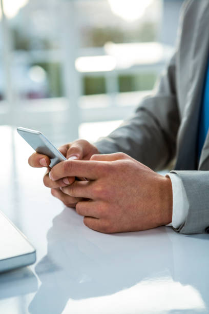 istock close up view of a businessman using his phone 675298622