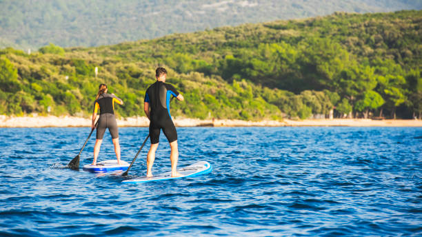 istock Two paddle boarders rowing towards the coast 675301230