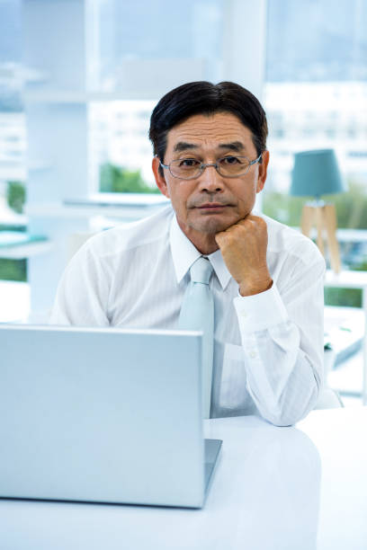 istock Thoughtful asian businessman looking at the camera 675301330