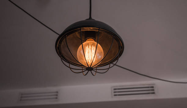 istock Decorative vintage style glowing light bulb, close-up view. 675301748