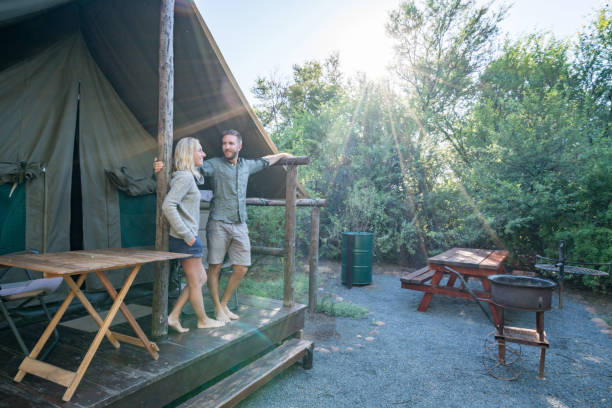 istock Two lovers enjoying vacations in nature, safari tent 675307590