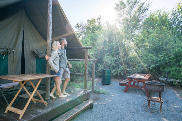 istock Two lovers enjoying vacations in nature, safari tent 675307640