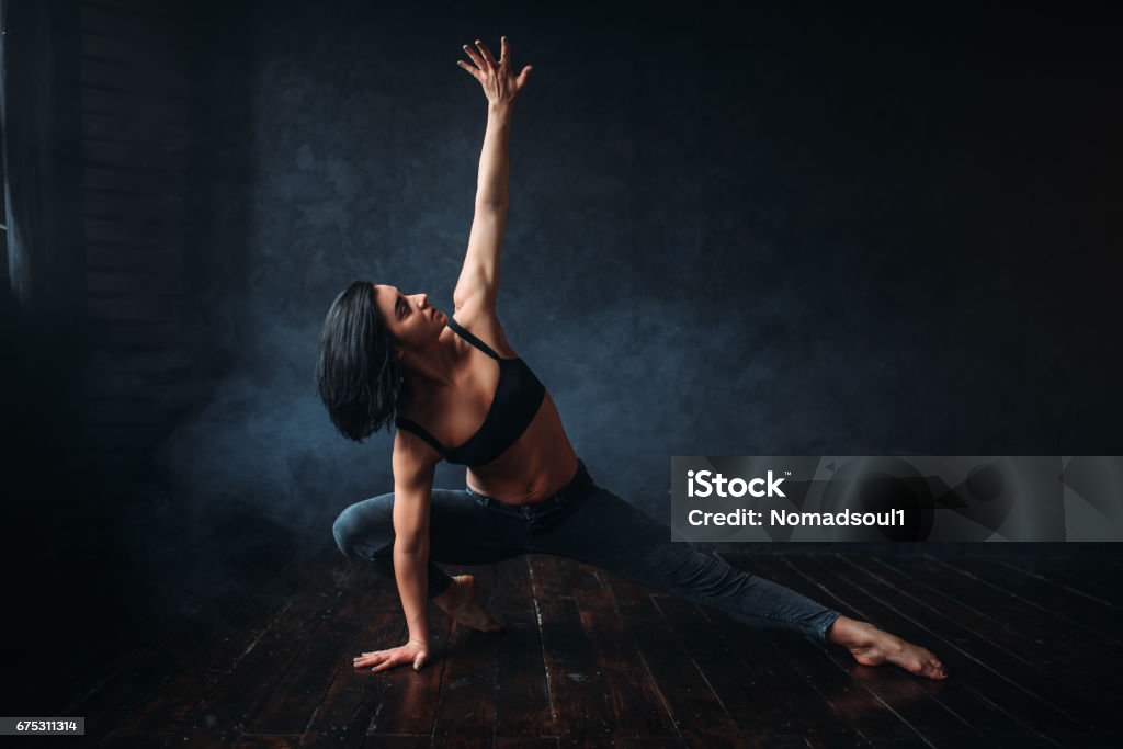 Contemp dancing female performer in dance class Contemp dancing female performer exercise in dance class. Woman pose in studio, acrobat body flexibility Active Lifestyle Stock Photo