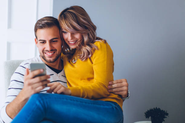 istock Couple having fun on smart phone 675314494