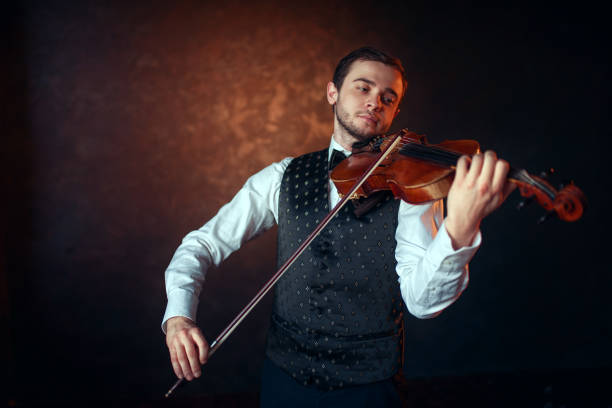 istock Male fiddler playing classical music on violin 675315112
