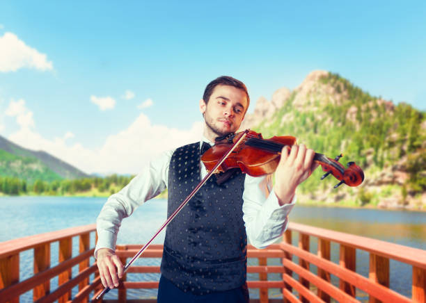 istock Male fiddler playing classical music on violin 675315456
