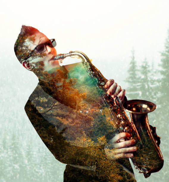 istock Saxophonist playing on saxophone, double exposure 675316540