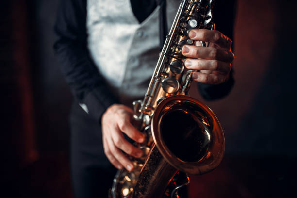 istock Jazz man hands holding saxophone closeup 675317848
