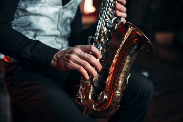 istock Jazz man hands holding saxophone closeup 675318238
