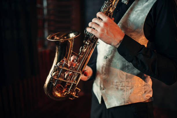 istock Jazz man hands holding saxophone closeup 675318304