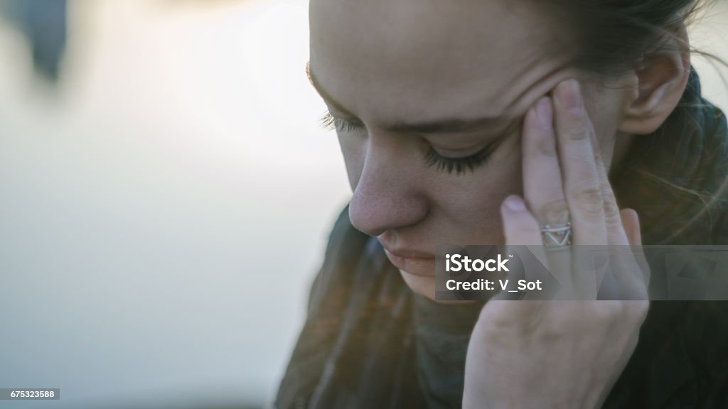 Young woman with sinus pressure pain Young woman with sinus pressure pain. Depressing state concept Headache Stock Photo