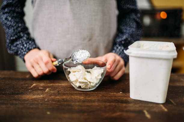 istock Female hands holds spoon with margarine over bowl 675324248