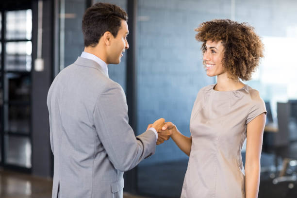 istock Businessman shaking hands young woman 675324626