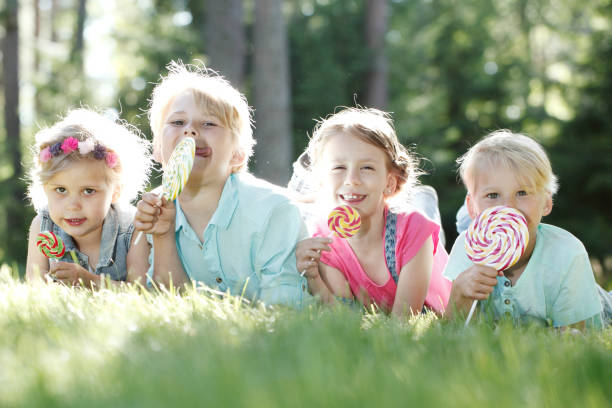 istock Happy children with lollipops 675324910