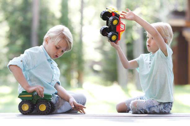 istock Kids playing with cars 675326762