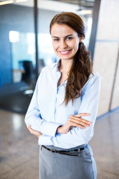 istock Young woman looking at camera in office 675327212