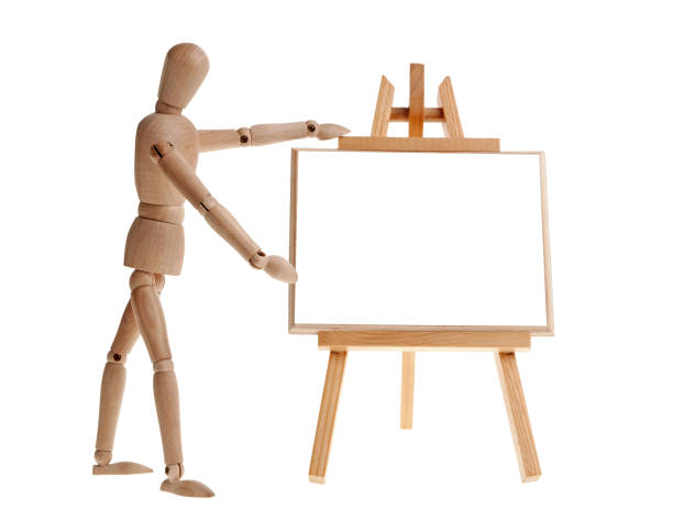 istock Wooden man pointing to easel 675331524