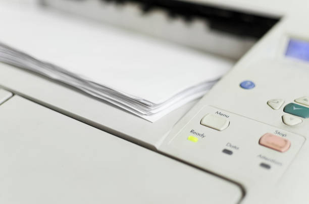 istock Printer in production with menu button and light blinking. Print and paper with dof copyspace 675334198
