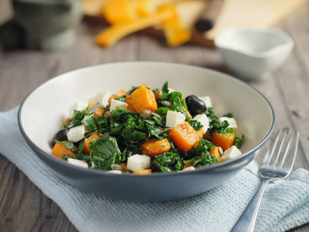 roasted butternut squash with kale and feta cheese stock photo