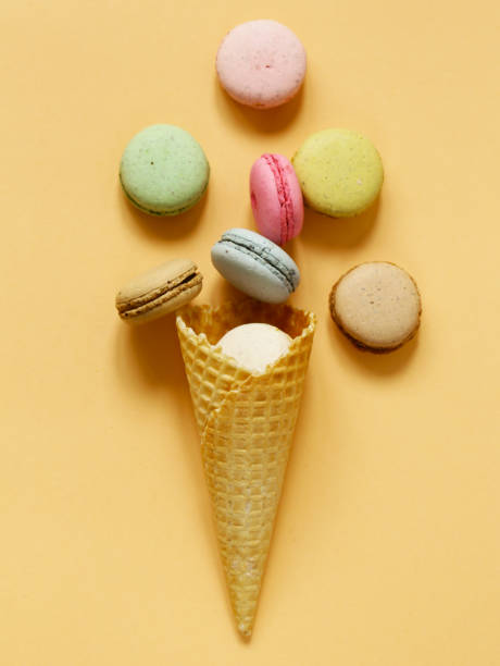 istock Colorful almond cookies  macaroons in a waffle cone 675337754