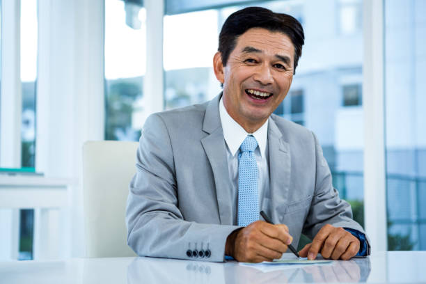 istock Happy businessman on his desk 675340630