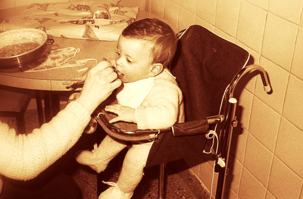 Sepia toned image of a baby being fed
