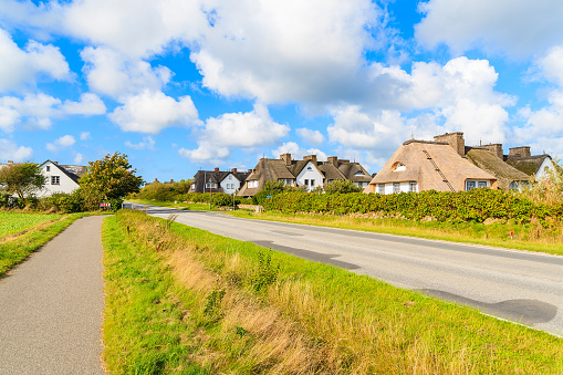 Road in Keitum village with typical straw roof houses on Sylt island, Germany