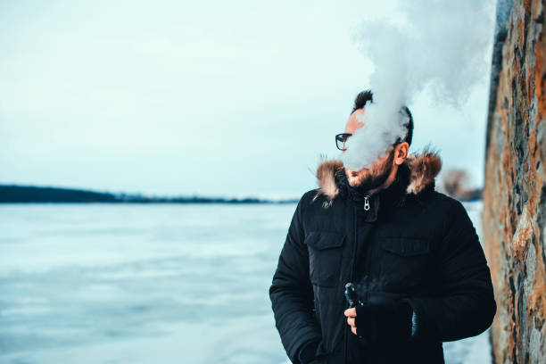 istock Man with beard smoke electronic cigarette outdoor 675343772