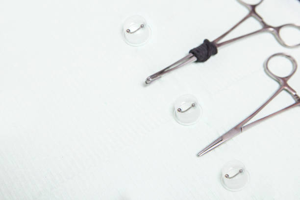 Piercing professional table with grips, forceps and jewels. Overhead shot