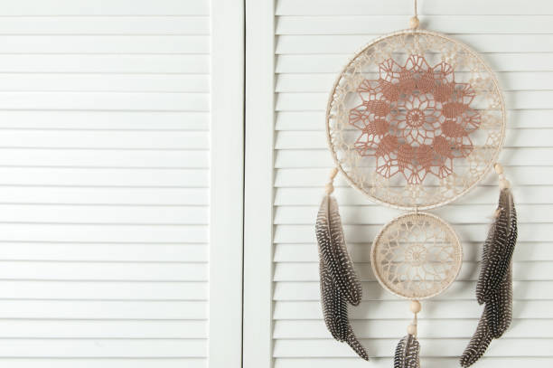 istock Beige brown dream catcher on white door 675364844