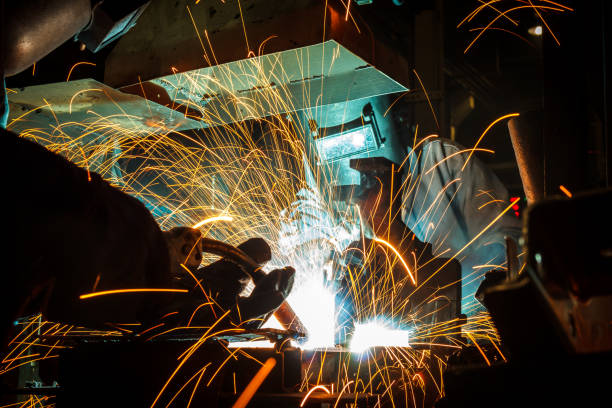 istock worker with protective mask welding metal 675365650