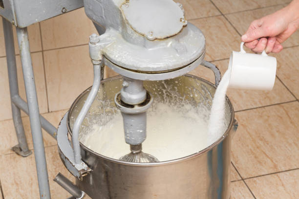 istock Chef preparing whipped cream and adding a sugar in the big mixer in the professional kitchen. Tasty, sweet meal. Healthy eating and lifestyle. 675369082