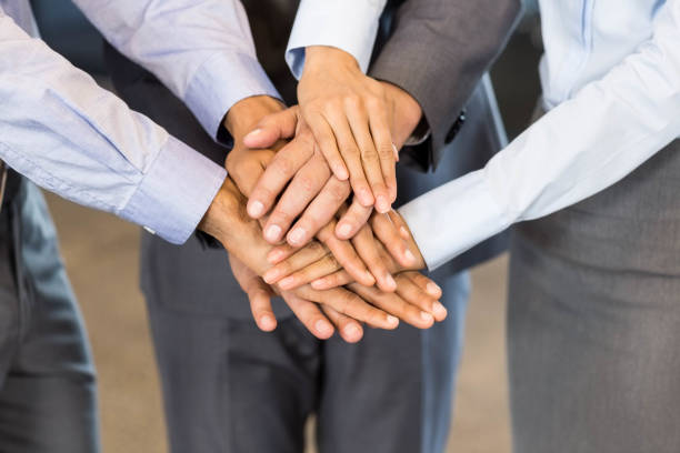 istock Close-up of businesspeople stacking hands 675369122