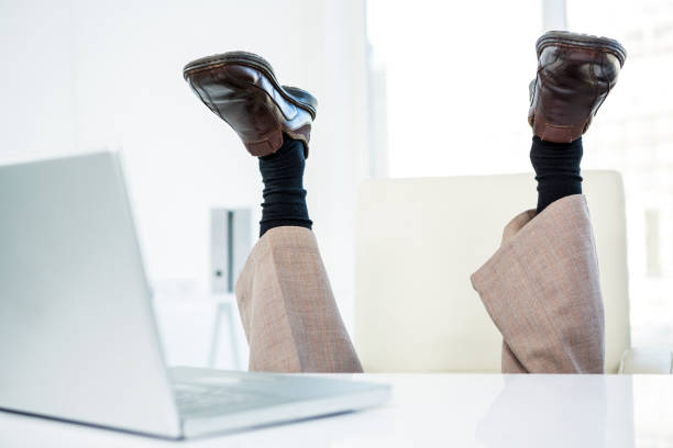istock Businessman lying on the ground with feet up 675372208