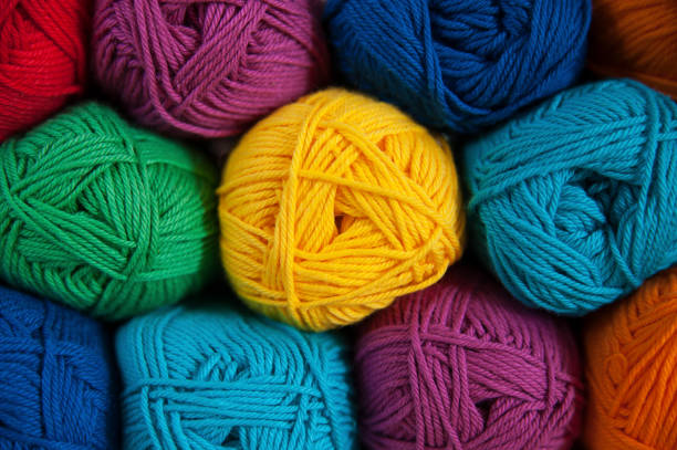 istock Symmetrically positioned rainbow colored cotton yarn background 675375992