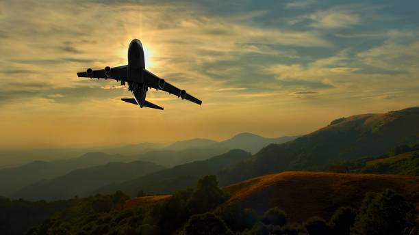 istock Commercial jet aeroplane maneuvering over mountain range 675379496