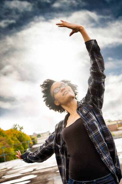 istock Tough young black millennial female dancing on Brooklyn rooftop 675379986